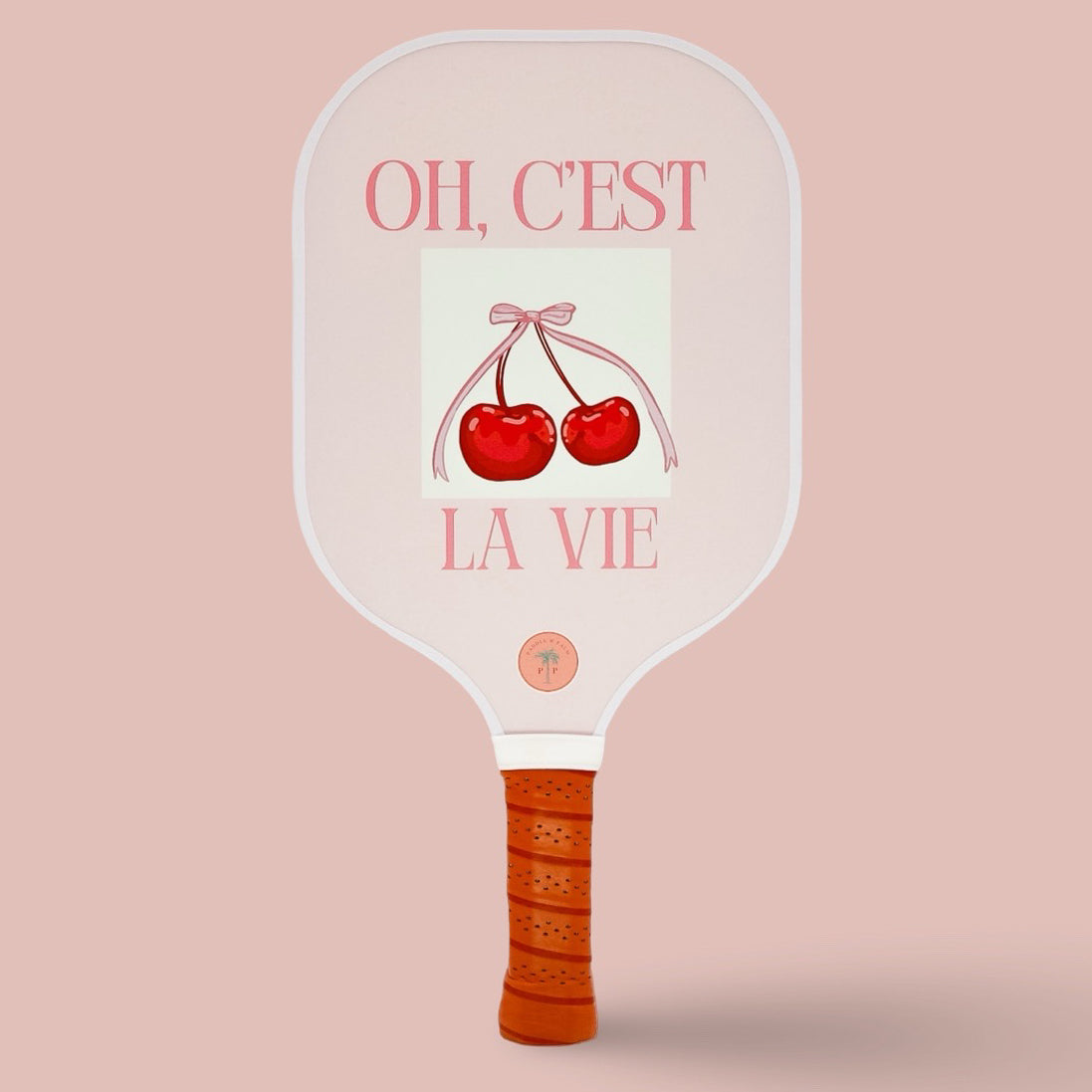 The front of a cute pickleball paddle with a picture of cherries