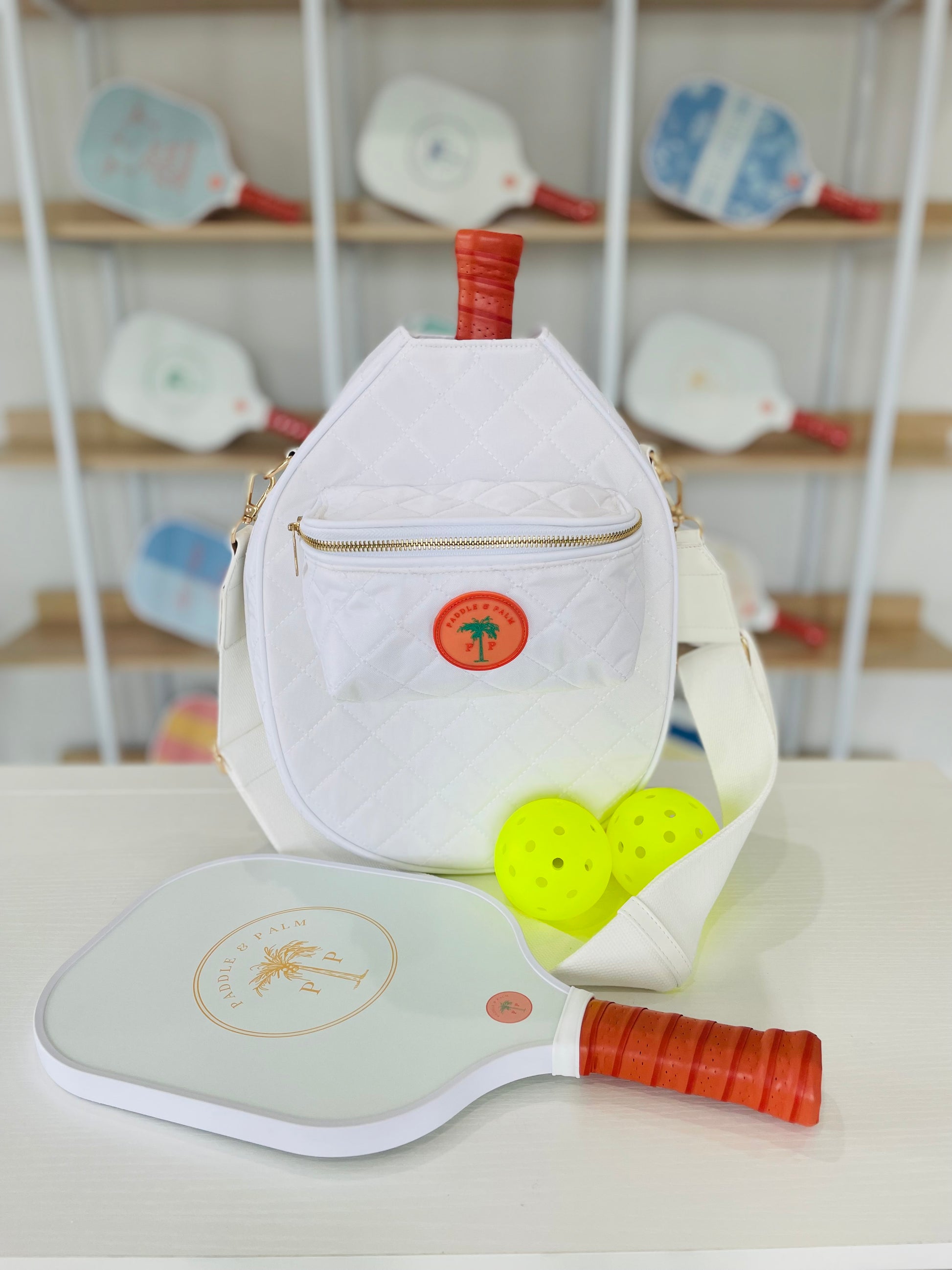 A cute pickleball bag with two paddles and two pickleballs