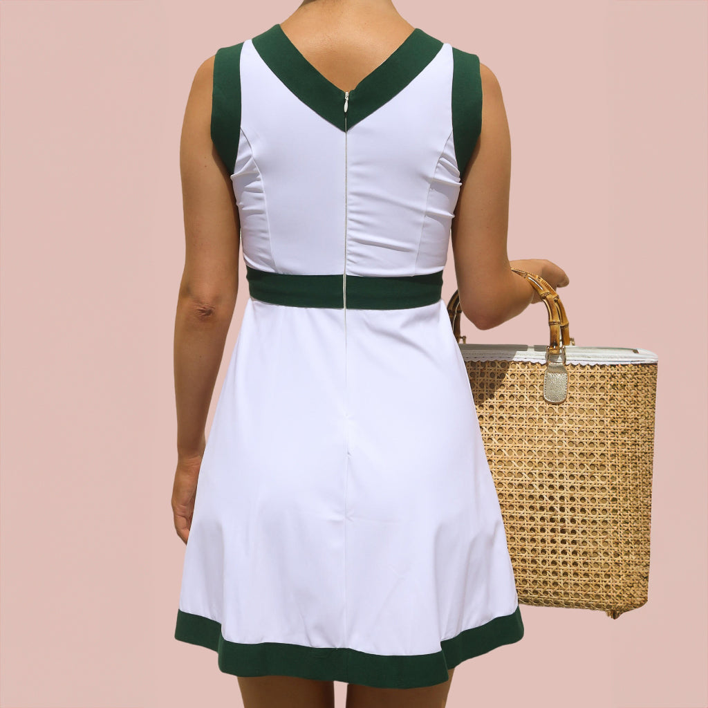 A woman wearing a white and green pickleball dress