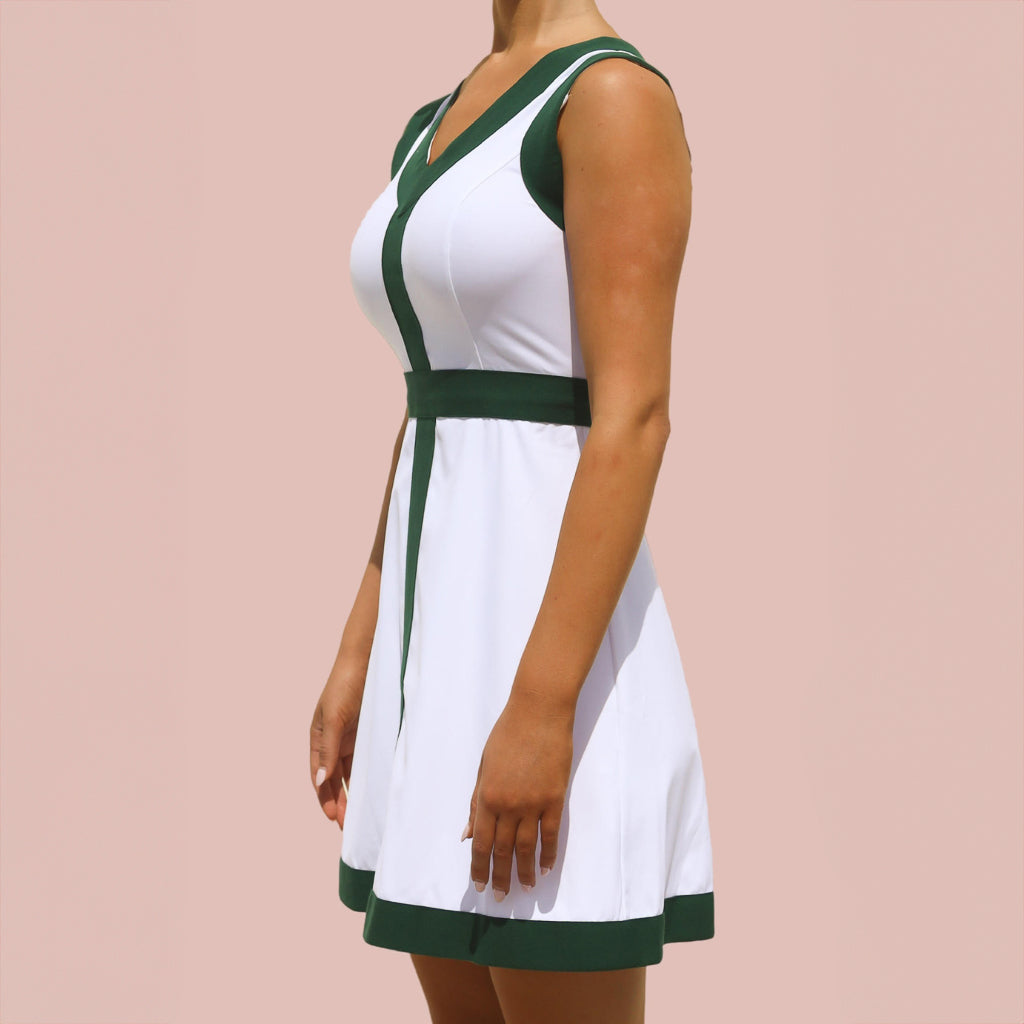 A woman wearing a white and green pickleball dress