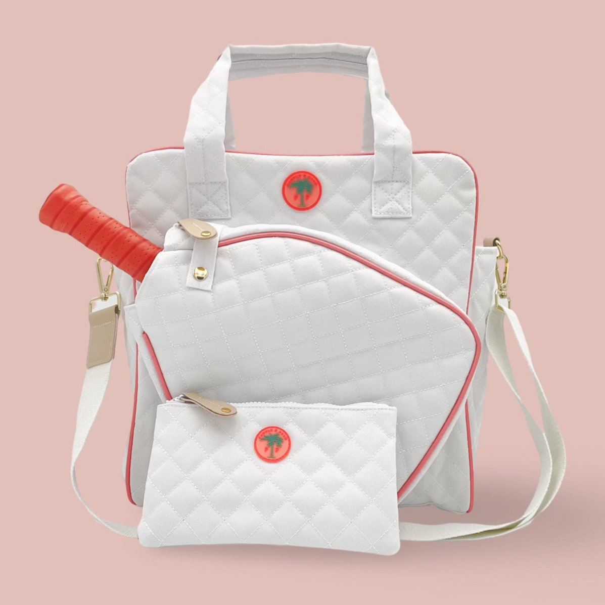 A quilted white and pink pickleball tote bag with matching ball pouch