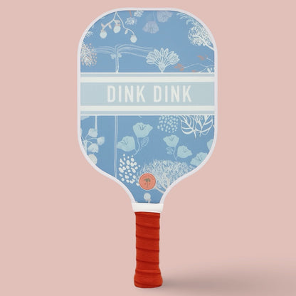 The front of a cute pickleball paddle with a blue design