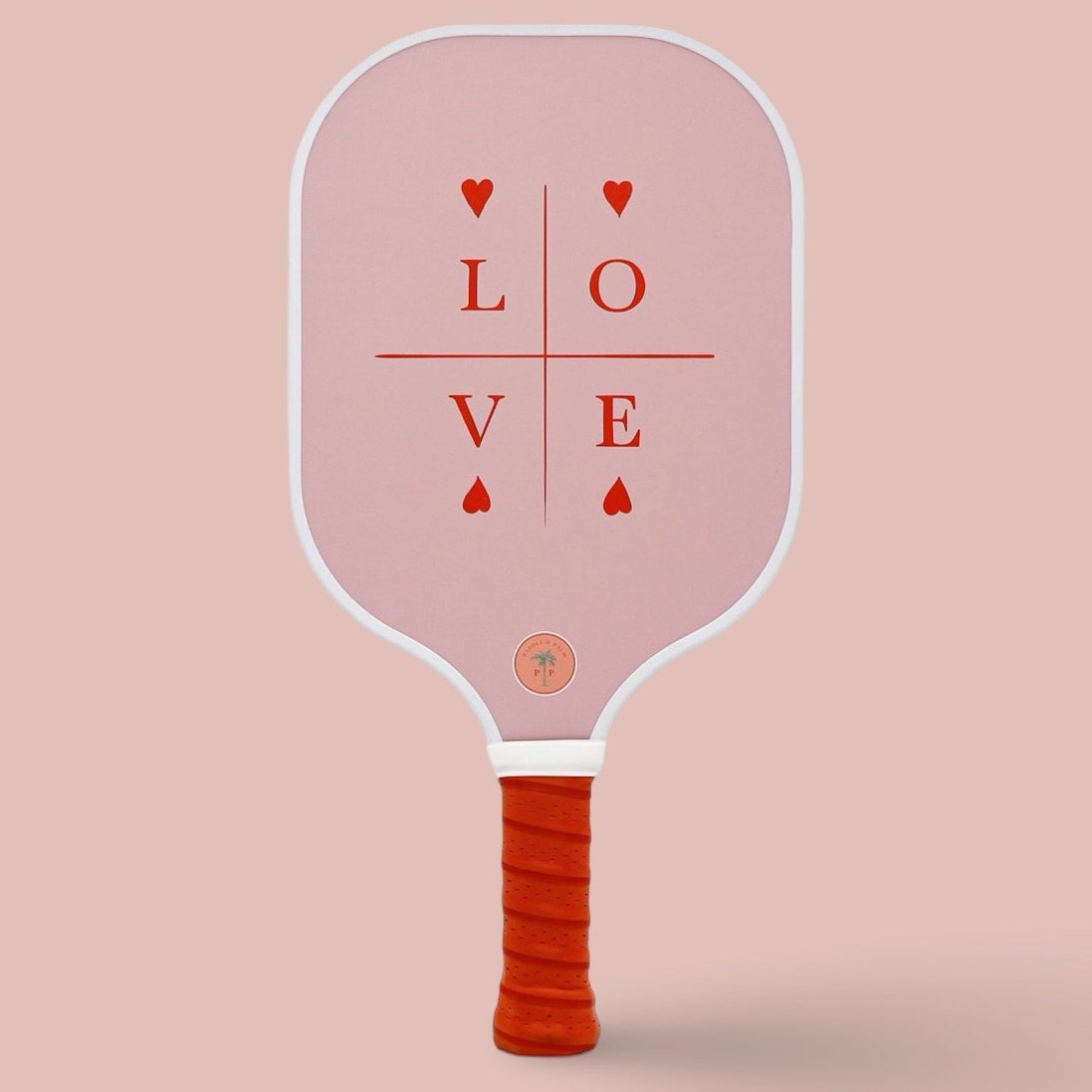 The back of a cute pickleball paddle with a pink and red design