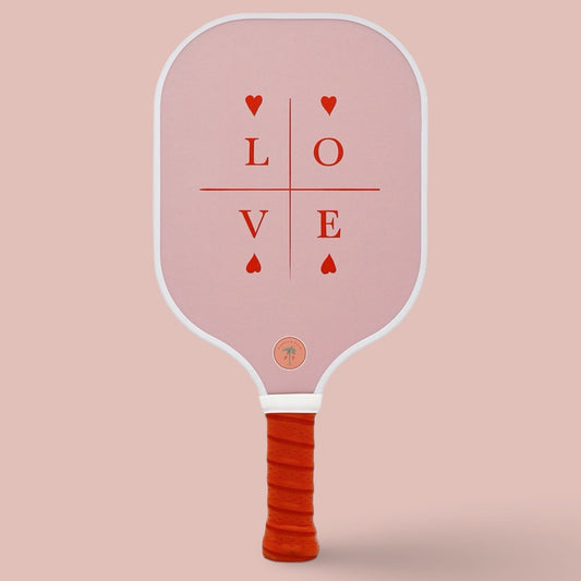 The back of a cute pickleball paddle with a pink and red design