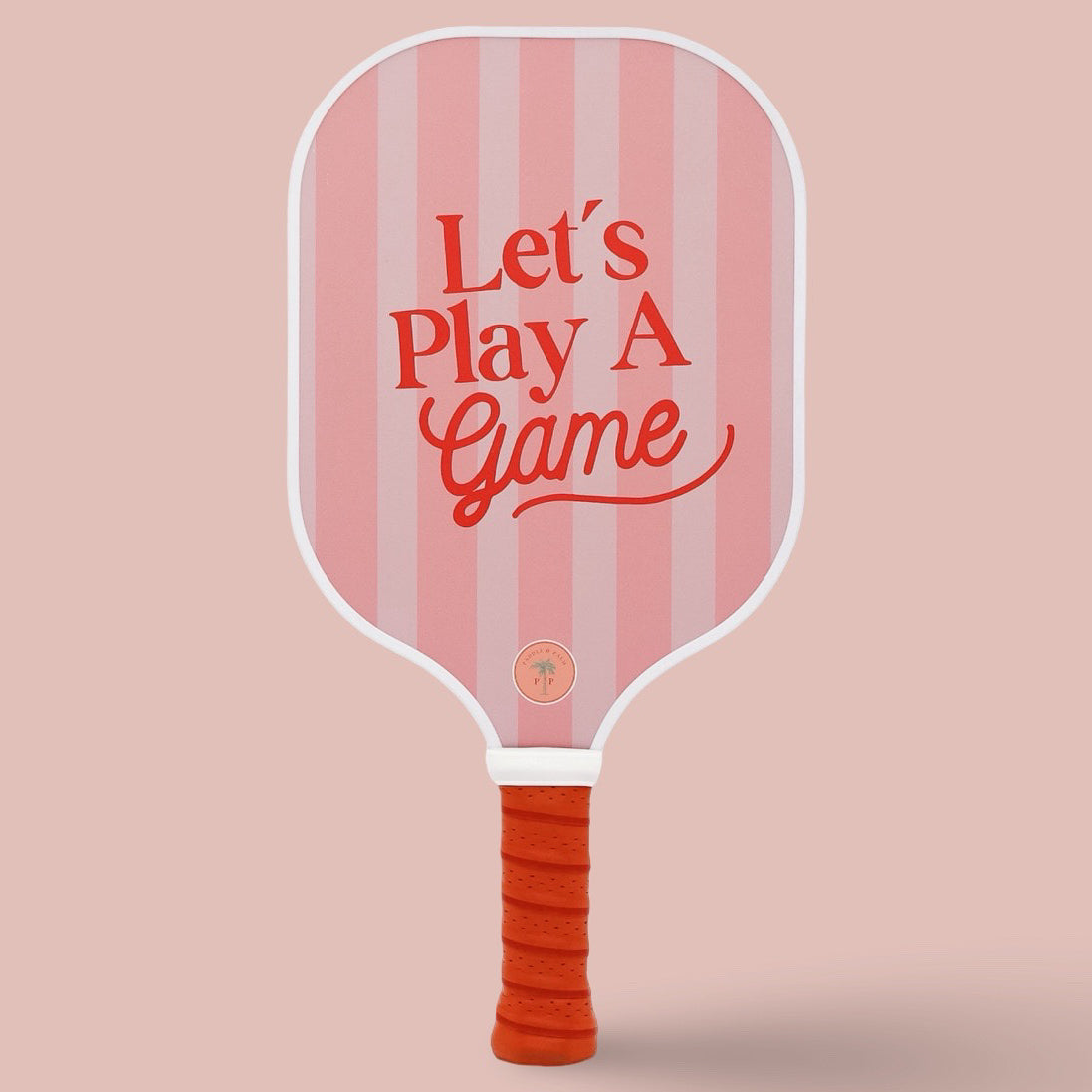 The front of a cute pickleball paddle with a pink and red design