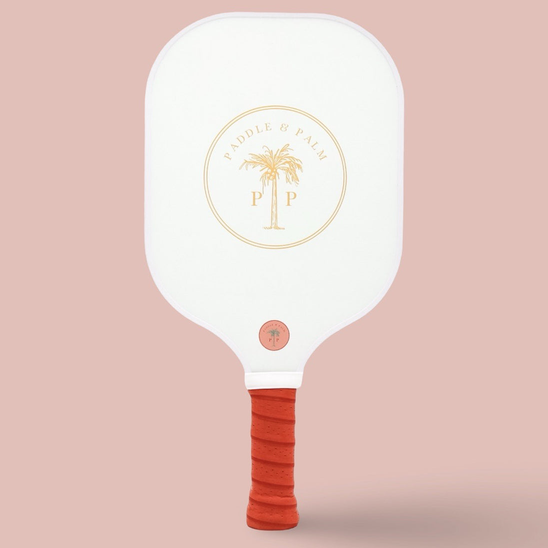 The back of a cute pickleball paddle with a yellow paddle and palm logo