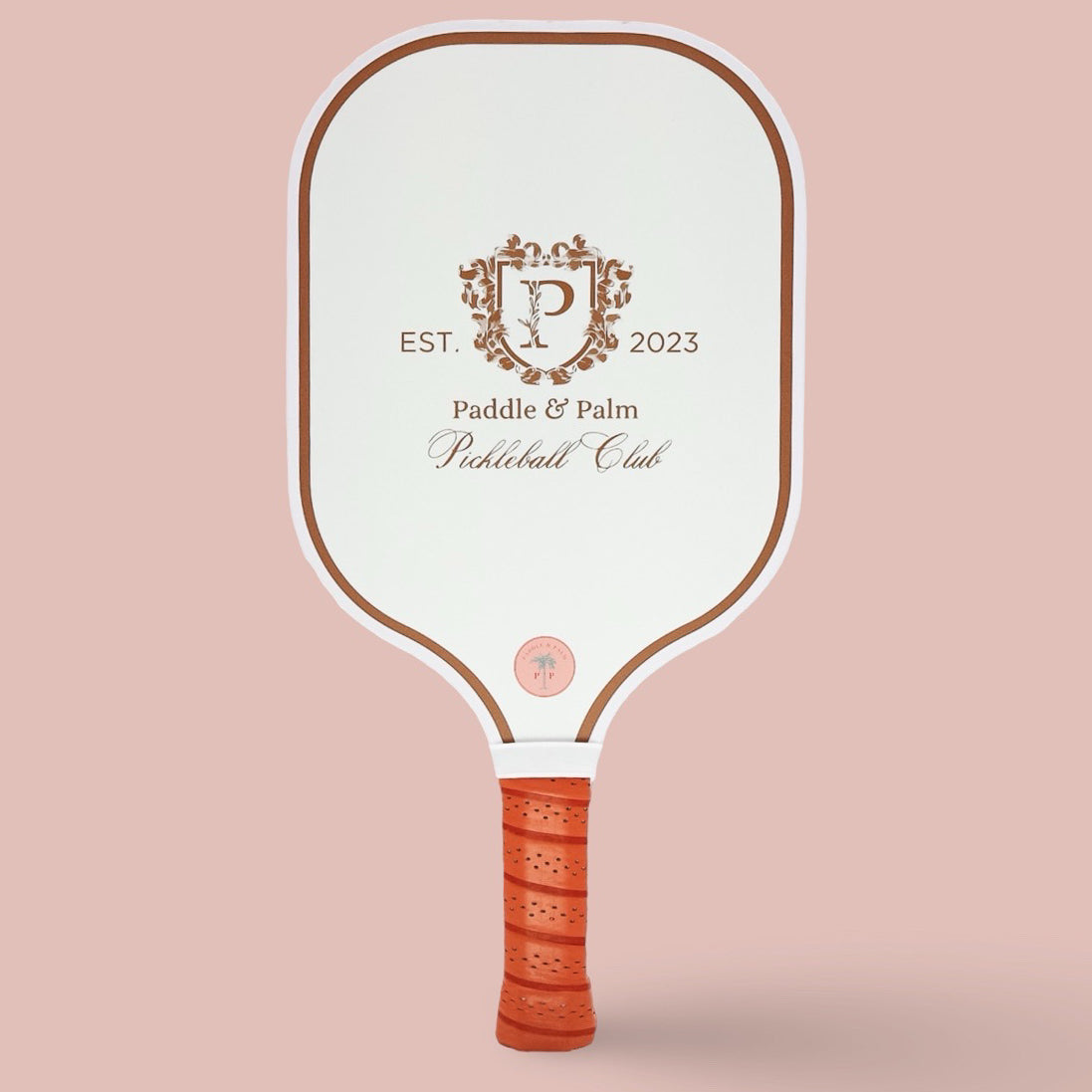 The front of a cute pickleball paddle with a white and gold design