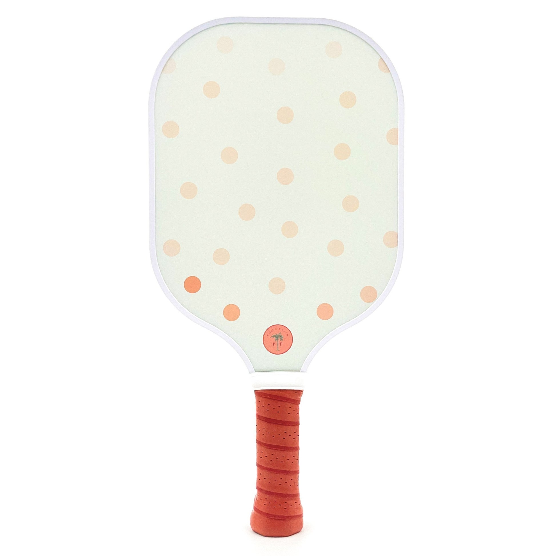 The back of a cute pickleball paddle with pink polka dots