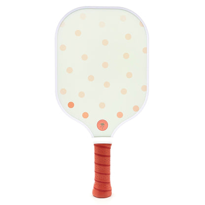 The back of a cute pickleball paddle with pink polka dots