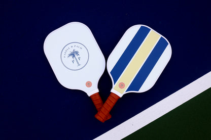 Both sides of a cute pickleball paddle with blue and gold designs